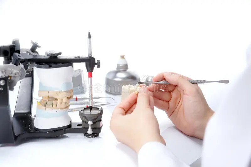 dental-technician-working-articulator-dental-laboratory-35321801.jpeg